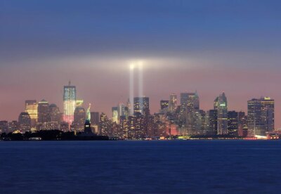 Free Photo | New york city manhattan downtown skyline panorama at night with statue of liberty and light beams in memory of september 11 viewed from new jersey waterfront.