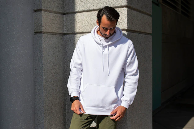 Free Photo | White hoodie on man with green pants in the city