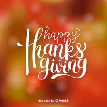 Free Vector | Happy thanksgiving lettering on blurred background