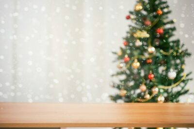 Free Photo | Empty christmas table background with christmas tree out of focus for product display montage