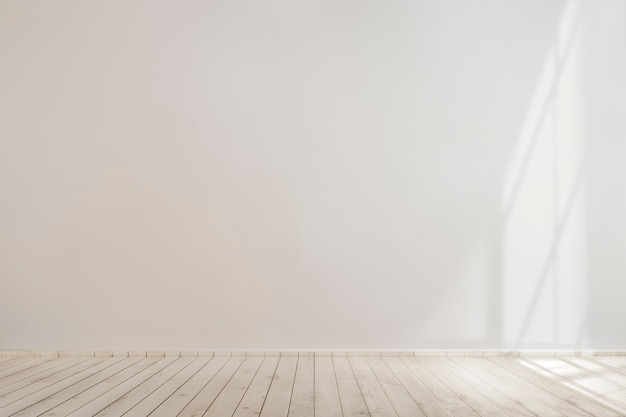 Free Photo | White blank concrete wall mockup with a wooden floor