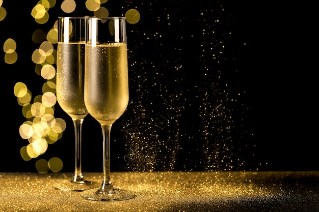 Free Photo | Champagne glasses with bokeh lights
