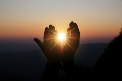 Free Photo | Spiritual prayer hands over sun shine with blurred beautiful sunset