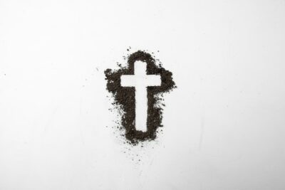 Free Photo | Top view of cross shape with dark soil on white
