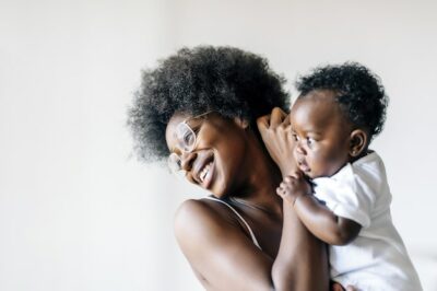 Free Photo | African-american mother taking care and loving her baby against a white background