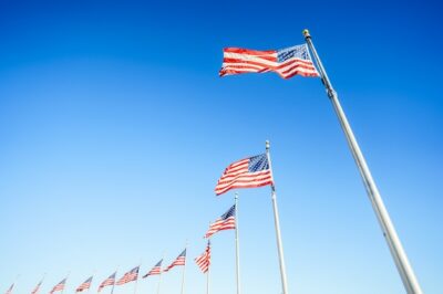 Free Photo | American flags on flagpoles on blue sky