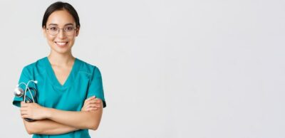 Free Photo | Covid-19, coronavirus disease, healthcare workers concept. close-up of confident professional female doctor, nurse in glasses and scrubs standing white background, cross arms.