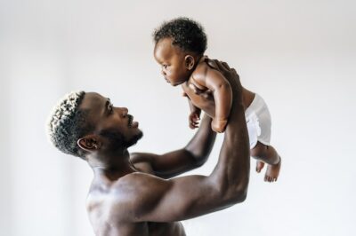 Free Photo | Cheerful african-american father taking care and having fun with his baby