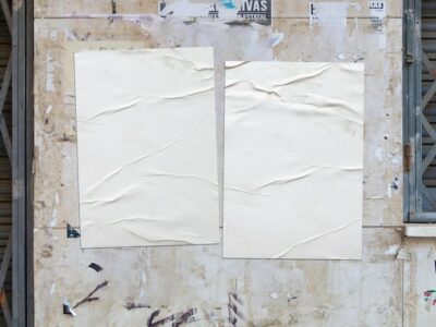 Free Photo | Two white crumpled posters on a grunge wall